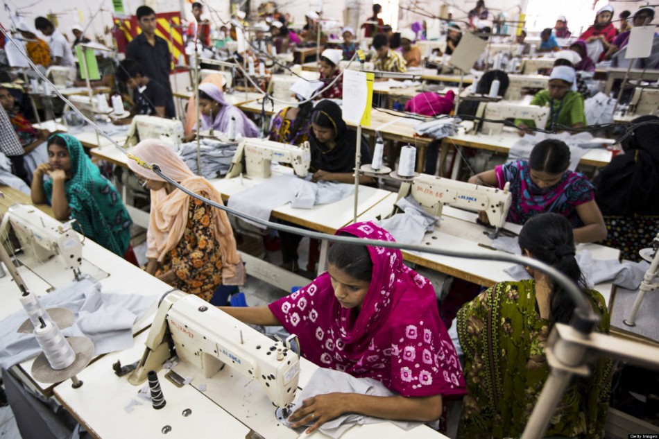 Workers sew garments on the production line of the Protik Apparels garment factory in Dhaka, Bangladesh, on Monday, April 29, 2013. Bangladesh authorities said they were accelerating rescue efforts at the factory complex that collapsed last week as hopes fade for more survivors after the nation's biggest industrial disaster. The government has decided to constitute a panel to identify garment factories in the country at risk of collapse, cabinet secretary Hossain Bhuiyan told reporters on April 29. Photographer: Jeff Holt/Bloomberg via Getty Images