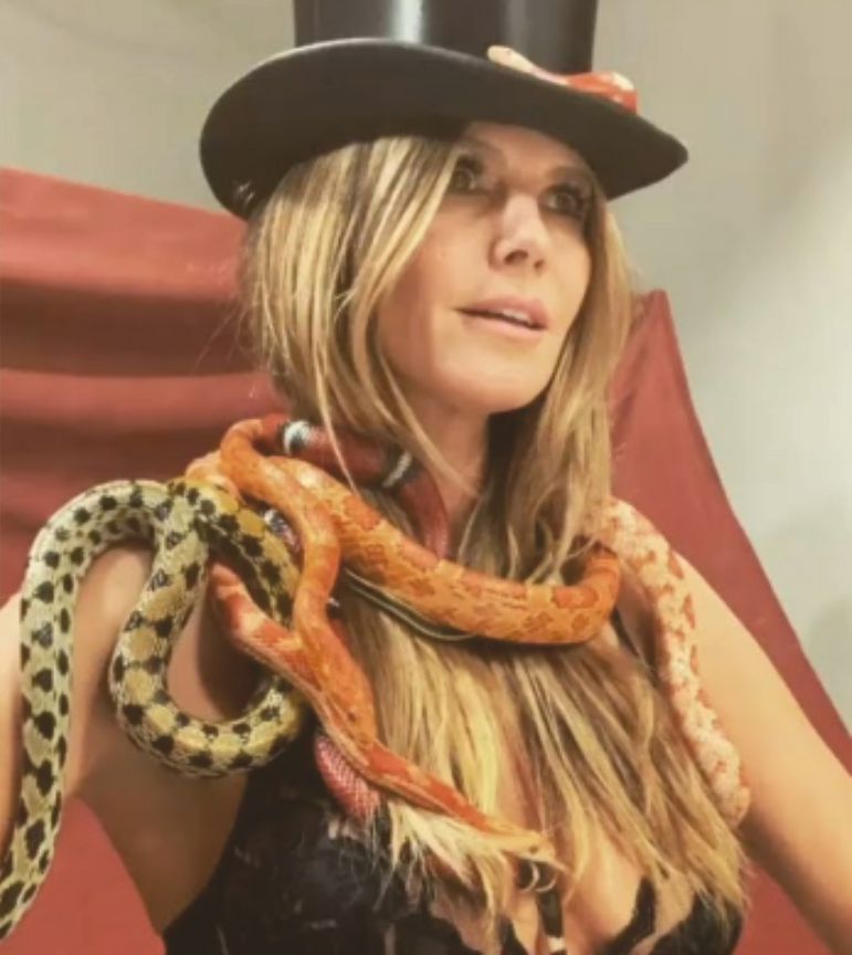 Heidi Klum models in lingerie with snakes around her neck